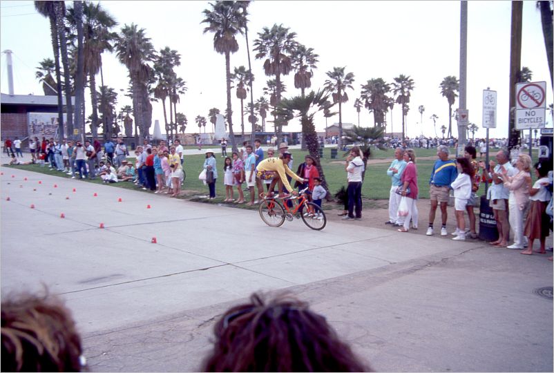 The guy that rides bikes standing on seat